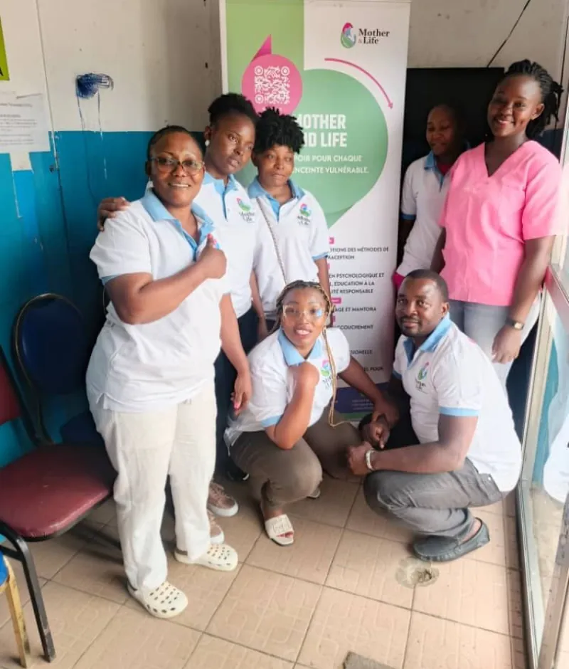 The Mother & Life team at a drop-in session, in front of the association’s banner.